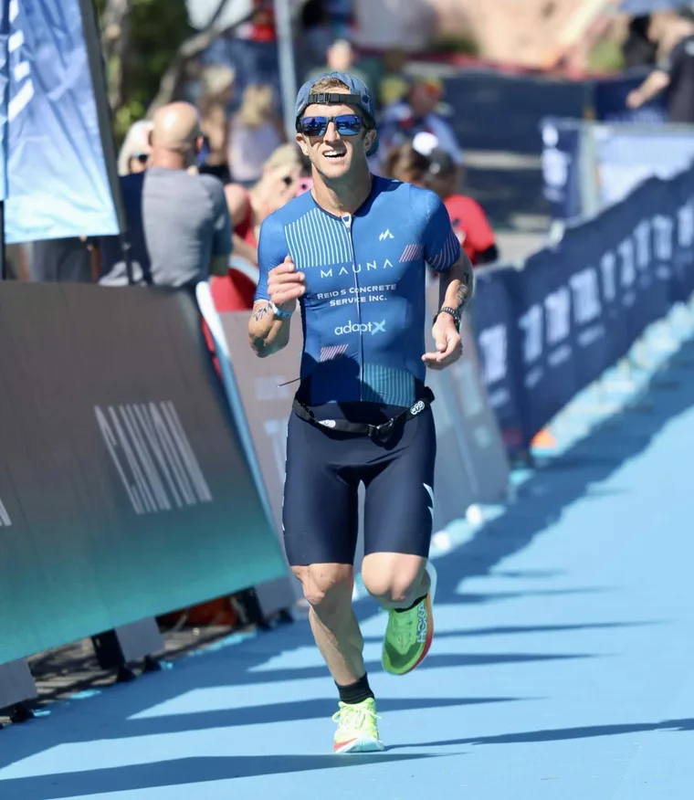 An athlete running toward a race finish line